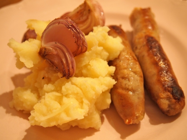 Sausages with caramalised onions and parmesan mash
